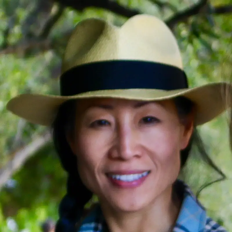 Home 5 Christy Hui, creator of Hulala Girls, smiling in a straw hat outdoors